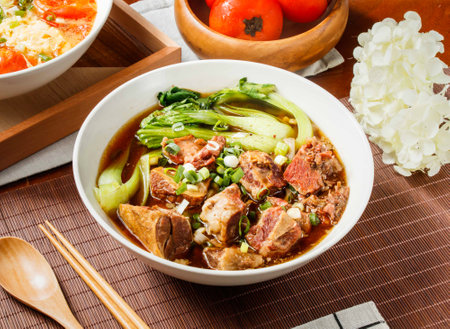 Beef Noodle Soup with Tender Braised Beef in bowl isolated on table side viewの写真素材