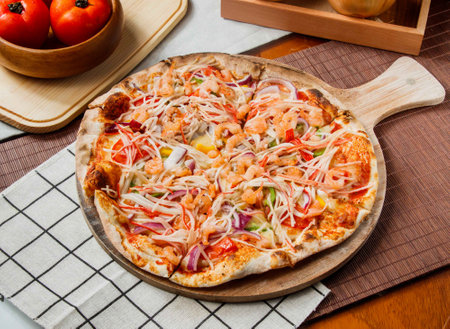 Seafood Extravaganza Pizza include shrimp, crab, squid, mussels with tomato sauce isolated on napkin and wooden cutting board side viewの写真素材