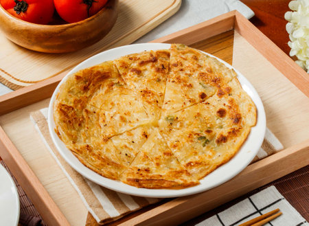 Crispy Scallion Pancake or paratha in plate served in wooden tray side view of taiwan foodの写真素材