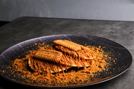 Chocolate Hazelnut Pancakes topped with crushed chocolate hazelnut cookies served in plate isolated...