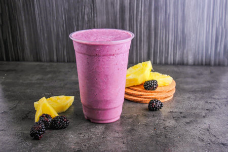 Blackberry Pineapple Smoothie served in glass isolated on background side view of healthy and delicious beverageの写真素材