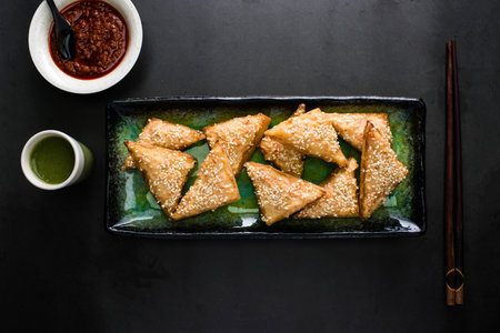 Prawn on Toast with red and green chilli paste sauce served in dish isolated on dark background top...