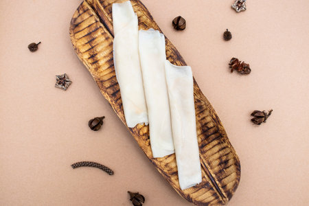 Patishapta served on wooden board isolated on brown background top view of foodの写真素材