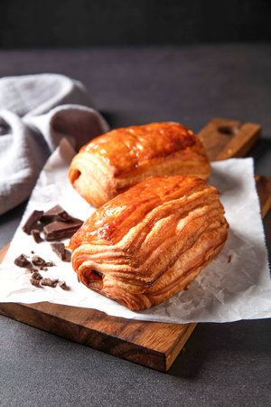Chocolate Shortbread puff pastry with fork served in dish isolated on dark background side view of baked cafe foodの写真素材