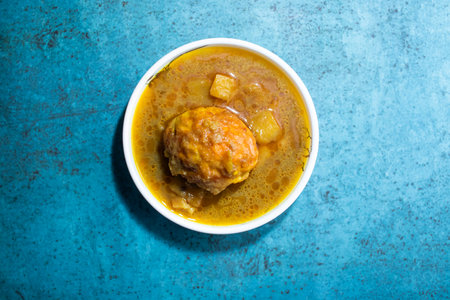 Egg curry with potato served in bowl isolated on sky background top view of bangladeshi foodの写真素材