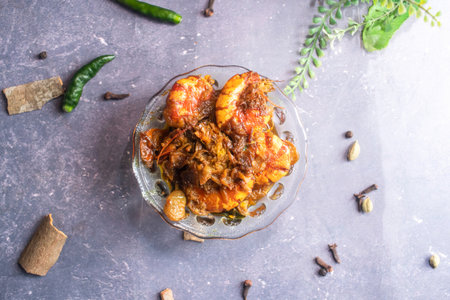 Fried shrimp or Chingri mach with onion served in bowl isolated on grey background top view of...