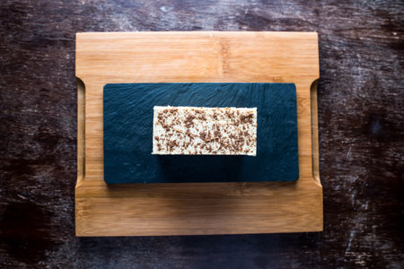 Tiramisu cake served on board isolated on table top view baked cafe sweet italian dessertの写真素材