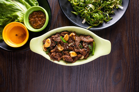 Goguryeo Beef Bulgogi with spicy sauce served in dish isolated on wooden table top view of korean foodの写真素材