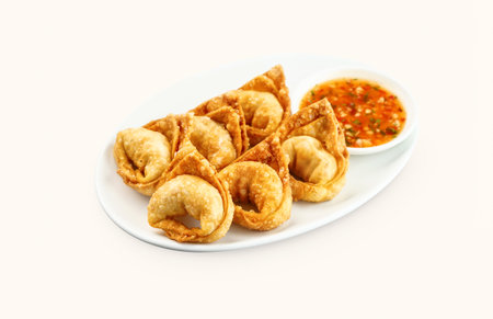Deep Fried Crispy Shrimp and Pork Wontons with chilli sauce served in plate isolated on grey background side view of hong kong foodの写真素材