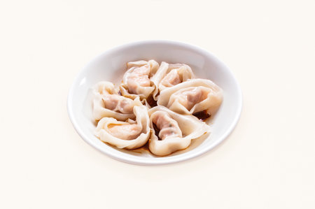 Dumplings, Wontons, Shao Mai, Shrimp and Pork Wontons with Soy Sauce served in plate isolated on grey background side view of hong kong foodの写真素材
