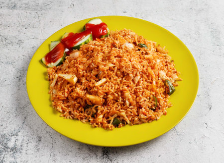 nasi goreng with cucumber served in dish isolated on grey background side view of singapore foodの写真素材