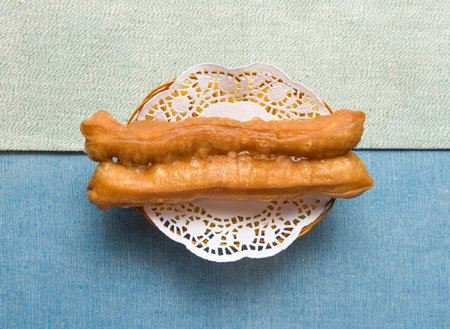 Deep Fried dough sticks served in basket isolated on napkin top viewの写真素材