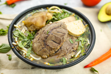 Bun Bo Hue beef noodles served in broth isolated on background side view of hong kong foodの写真素材