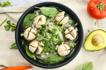 Pork ball noodles soup river with spring onion and green leaves served in broth isolated on...