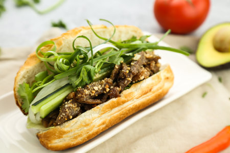 Roast pork baguette with cucumber, onion served in dish isolated on table side view of fastfood chineseの写真素材