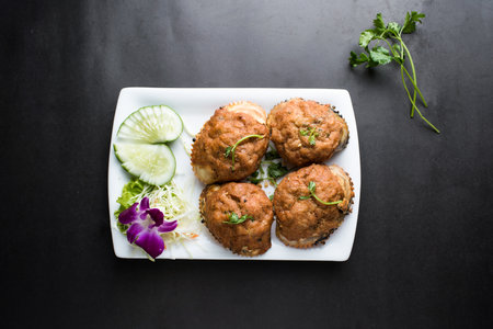 Stuffed Crab with Herbs, cucumber served in dish isolated on dark background top view of thai foodの写真素材