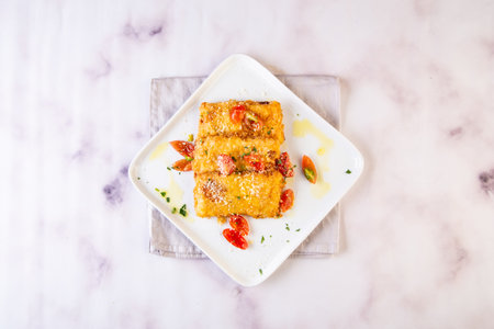 Fried Mozzarella Cheese sticks with cherry tomato served in dish isolated on grey background top viewの写真素材
