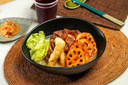 lotus root Cart Noodles pot with, lettuce leaf, drink and chopsticks served in pot isolated on napkin side view of japanese foodの写真素材