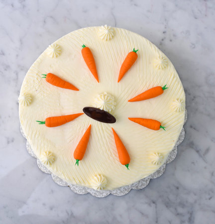 Decorated Carrot Cake, featuring moist and spiced cake layers covered in smooth cream cheese frosting top view of delicious cakeの写真素材