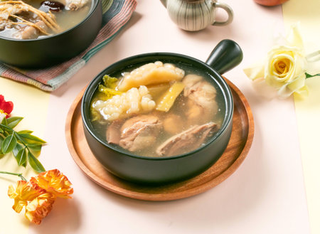 Pineapple Bitter Melon Chicken Soup served in bowl on wooden tray side view of taiwan hot soupの写真素材