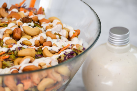 Broccoli Cashew Salad in a glass bowl include broccoli, cashews, and other vegetables closeup side view of gourmet nut saladの写真素材