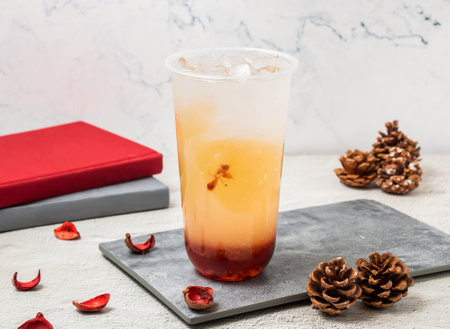 Strawberry Lemon ice tea served in disposable glass isolated on board side view of taiwanese iced...