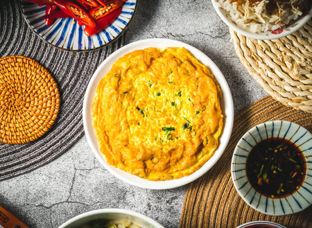 Fried scallions eggs omelet served in plate isolated on grey background top view of assorted taiwan foodの写真素材