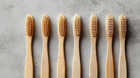 Wooden toothbrushes on grey textured background, top viewの素材