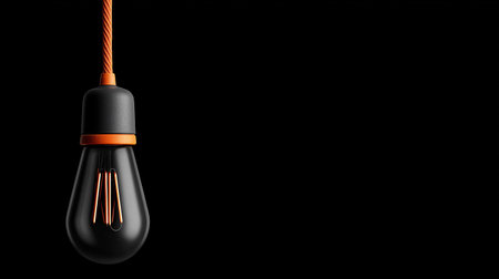 3d rendering of a light bulb on a black background with copy spaceの素材