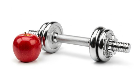 Dumbbells and red apple isolated on a white background.の素材