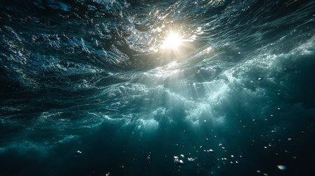 Underwater view of the ocean surface with sunbeams and wavesの素材
