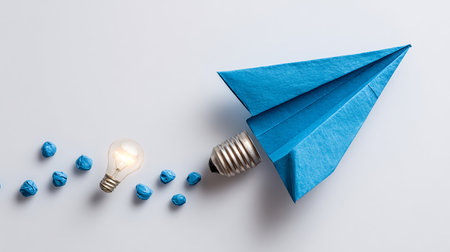 Paper plane and lightbulb on white background. Business idea conceptの素材