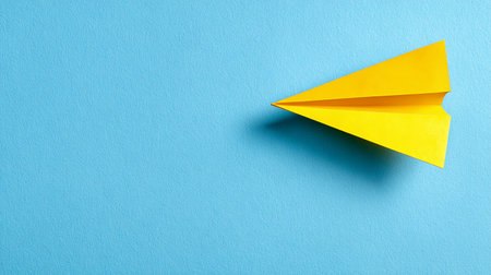 Paper plane on blue background, top view with copy space for textの素材