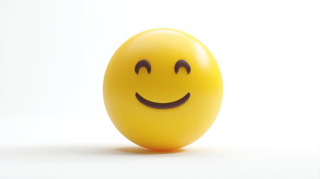 Smiling yellow emoticon on white background, closeup of photoの素材
