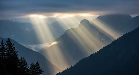 Sun rays shining through the clouds over the mountains in the Dolomitesの素材