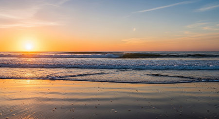 Sunset on the beach with waves and sand in the foreground.の素材