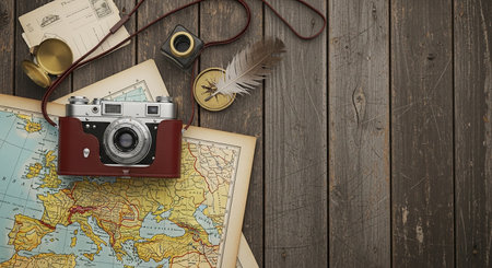 Vintage camera, map and travel items on old wooden background.の素材