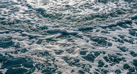Sea waves with foam and water splashes, view from above.の素材