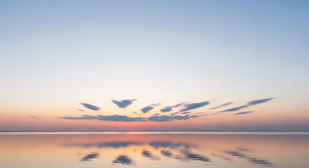 Beautiful sunset on the beach with reflection in water. Nature backgroundの素材