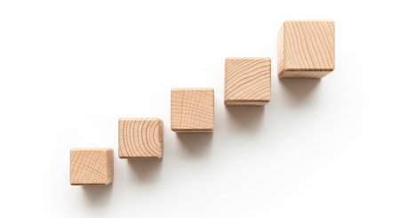 Wooden block stacking as step stair on white background, business growth conceptの素材