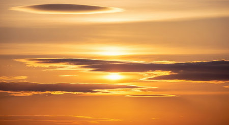 Sunset sky with clouds and sunbeams. Nature background.の素材