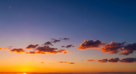 Sunset sky background with tiny clouds. Sunset sky with tiny clouds.の素材