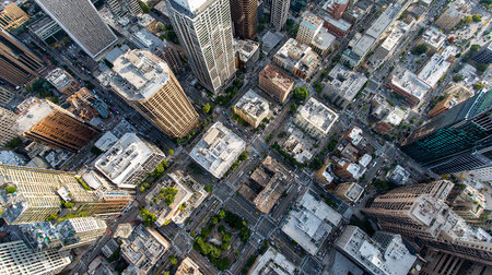 Aerial city view with crossroads and roads, houses, buildings, parks and parking lots, bridgesの素材