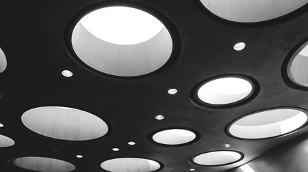 Circles on the ceiling of a modern office building in black and whiteの素材