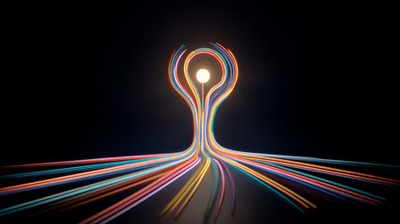 abstract colored lines on a black background with a light bulb in the centerの素材