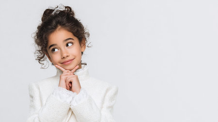 portrait of cute little girl in white sweater, isolated on greyの素材