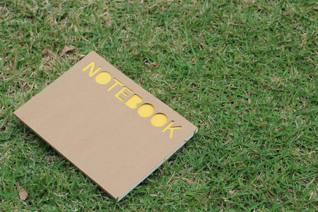 notebook on the green field