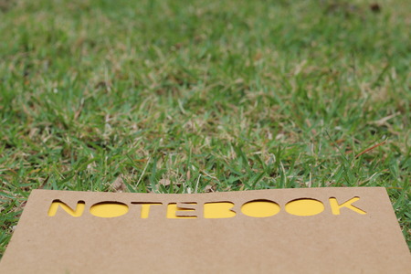 notebook on the green grass