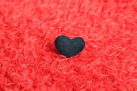 black heart on red pillowの写真素材