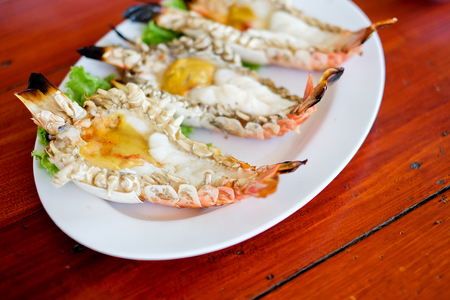 big river shrimp Grilled with white dish on wood texture backgroundの写真素材